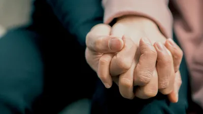 A couple showing physical touch by holding hands