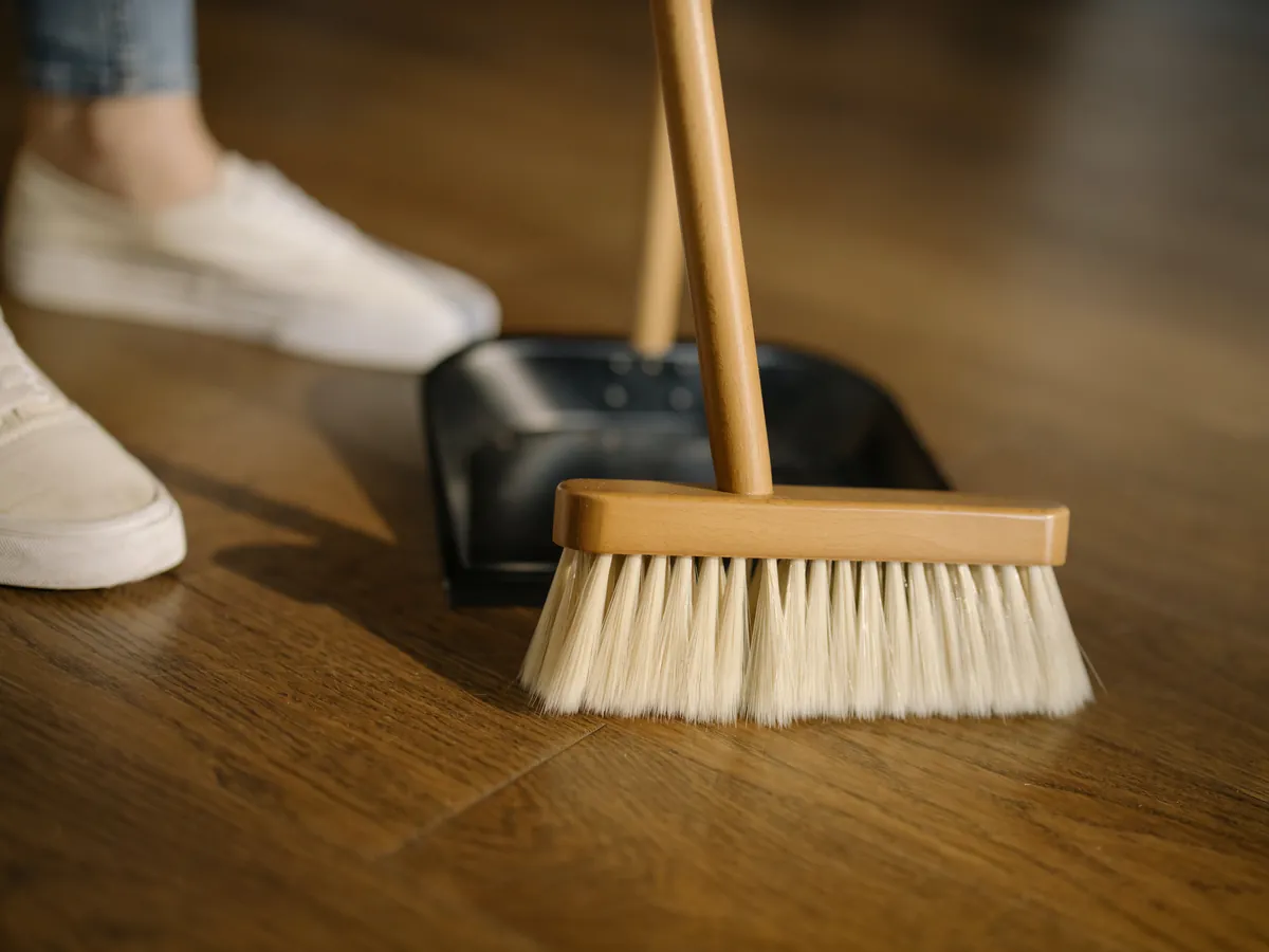 A spouse sweeping the floor for their spouse
